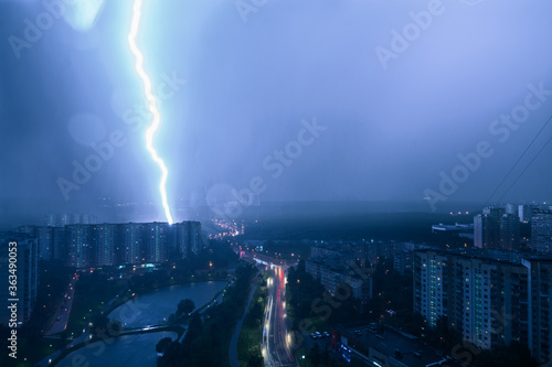 Extremely close lightning strike into a block flats at night in Moscow