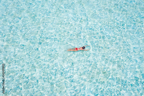 Top above high angle aerial drone view of pure clean clear ocean water pool poolside plage girl diving searching fish coral reef luxurious hotel destination open borders tour tourism egypt turkey