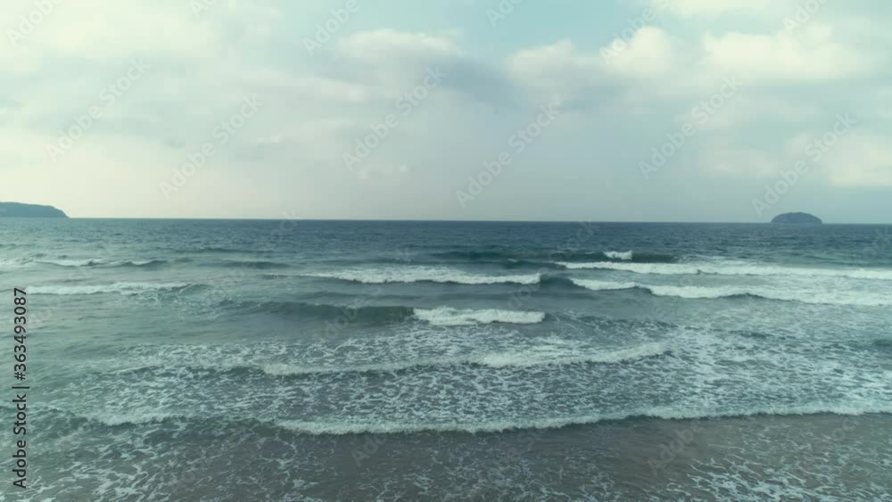 Aerial view of blue ocean with beautiful foaming rolling waves at cloudy day. Travel concept. Nacpan beach, Palawan, Philippines. Aerial view of blue ocean with beautiful foaming rolling waves at cloudy day. Travel concept. Nacpan beach, Palawan, Philippines.