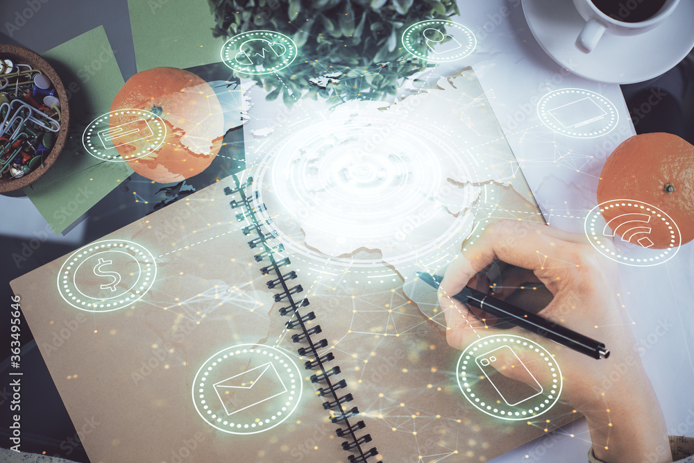 Social network theme hologram over hands taking notes background. Concept of global international people connect. Double exposure Social network theme hologram over hands taking notes background. Concept of global international people connect. Double exposure