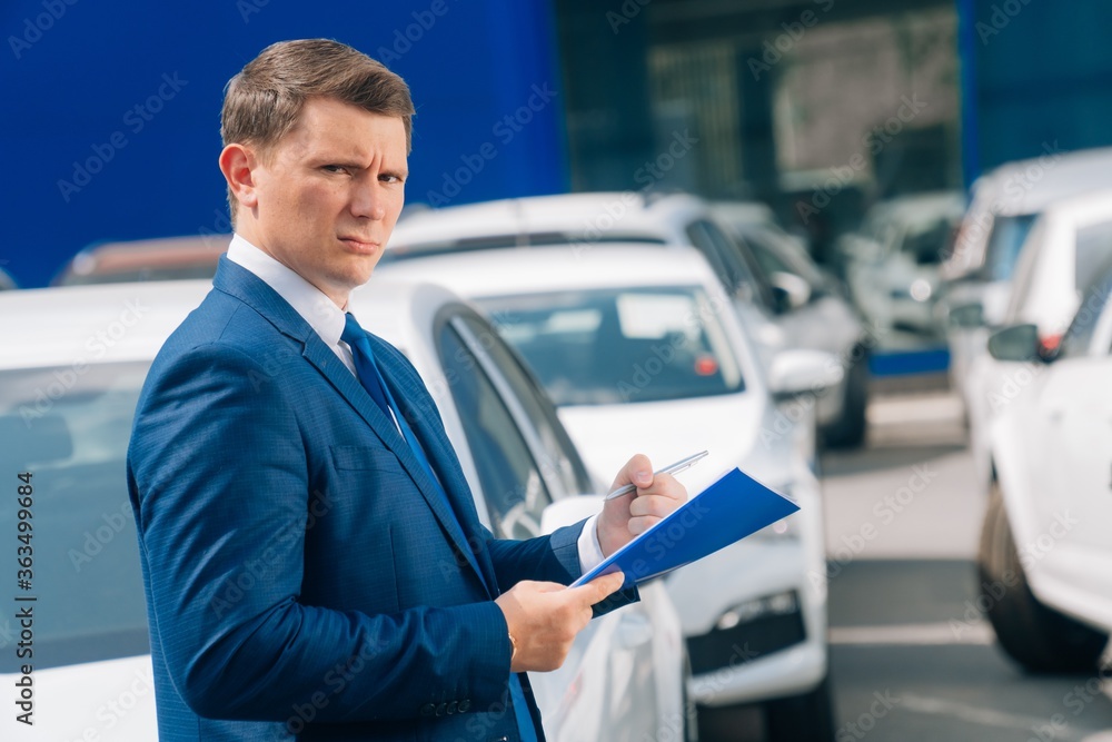 A man writes in a tablet next to the car. An accident on the road, the airbag didn't work. A man writes in a tablet next to the car. An accident on the road, the airbag didn't work.