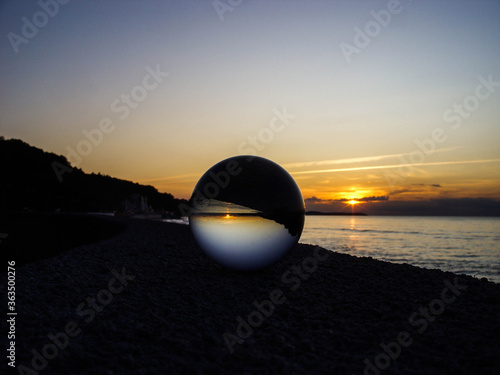 Glass ball on a background of the sea