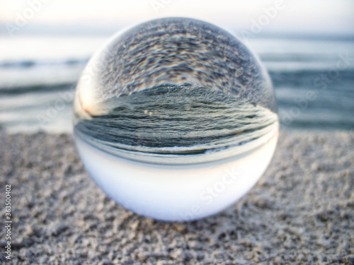 Glass ball on a background of the sea