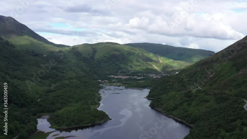 aerial footage over loch leven showing kinlochleven on the west highland way long distance hiking trail in the argyll and lochaber region of the highlands of scotland during a summer evening photo