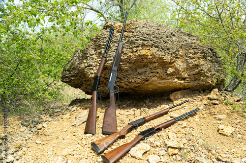 rifles lie by the rocks