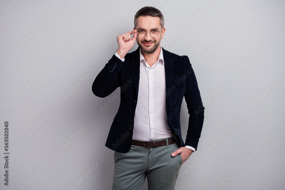 Portrait of his he nice attractive cheerful content successful mature man specialist wearing elegant look touching specs posing isolated over light gray pastel color background Portrait of his he nice attractive cheerful content successful mature man specialist wearing elegant look touching specs posing isolated over light gray pastel color background