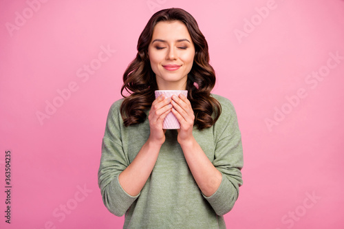 Close-up portrait of her she nice attractive lovely charming pretty dreamy winsome cheerful cheery wavy-haired girl drinking sweet tea isolated over pink pastel color background