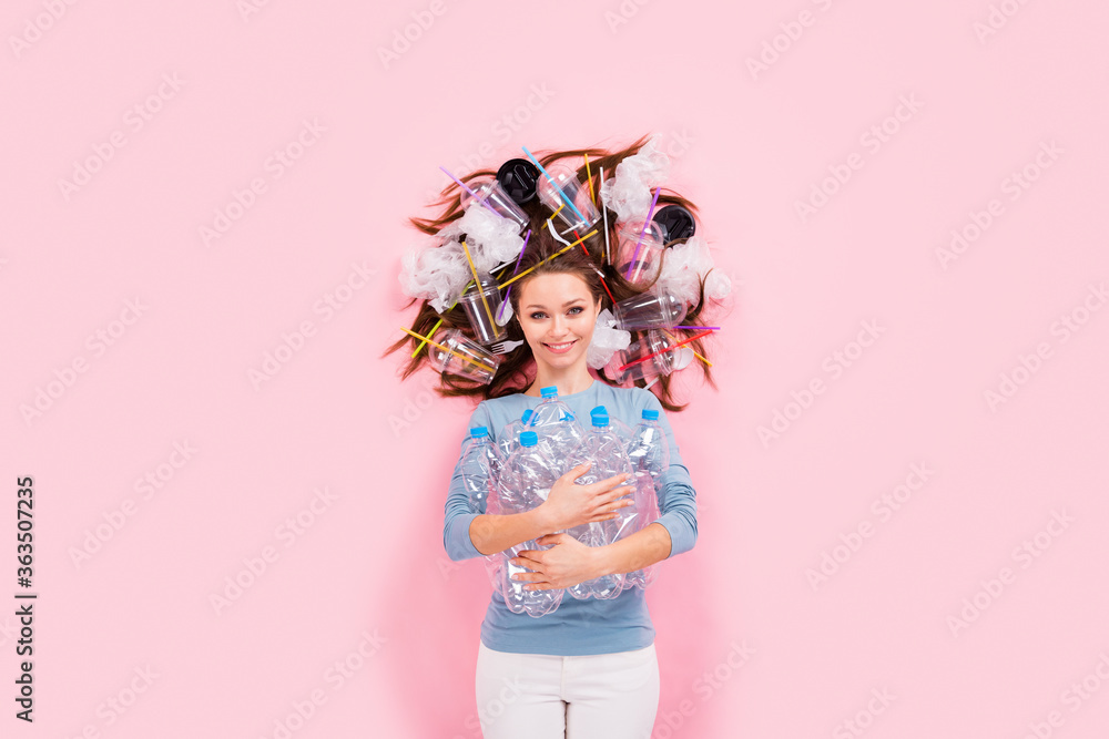Top above high angle view photo of positive eco activist girl collect rubbish hold empty water bottle hair plastic bags mug wear jumper sweater lay isolated over pastel color background Top above high angle view photo of positive eco activist girl collect rubbish hold empty water bottle hair plastic bags mug wear jumper sweater lay isolated over pastel color background