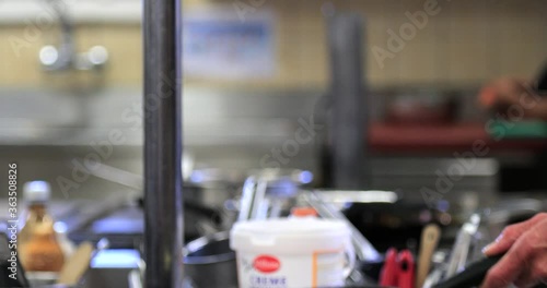 Wallpaper Mural Flipping Pan of Potatoes Rösti in Kitchen. Torontodigital.ca