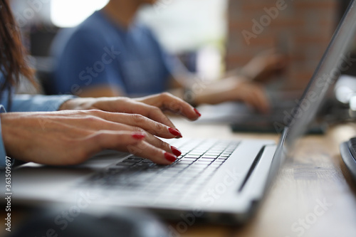 Woman in office is typing on keyboard. Learning new professions online concept