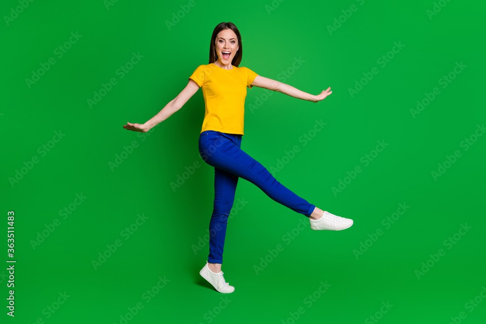 Full length body size view portrait of her she nice-looking attractive lovely cheerful cheery careless funky girl jumping going having fun isolated bright vivid shine vibrant green color background Full length body size view portrait of her she nice-looking attractive lovely cheerful cheery careless funky girl jumping going having fun isolated bright vivid shine vibrant green color background