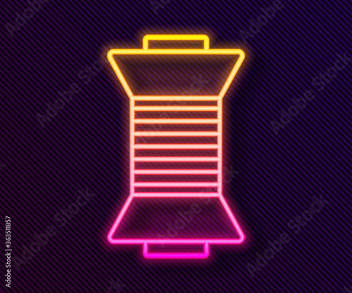Glowing neon line Sewing thread on spool icon isolated on black background. Yarn spool. Thread bobbin. Vector Illustration.