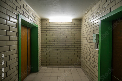 Fotografie Room with elevators of a Soviet apartment building of the 80s, lined with glazed ceramic tiles