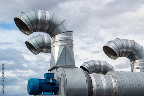The galvanized pipes of the branching system are installed on the roof of the building.