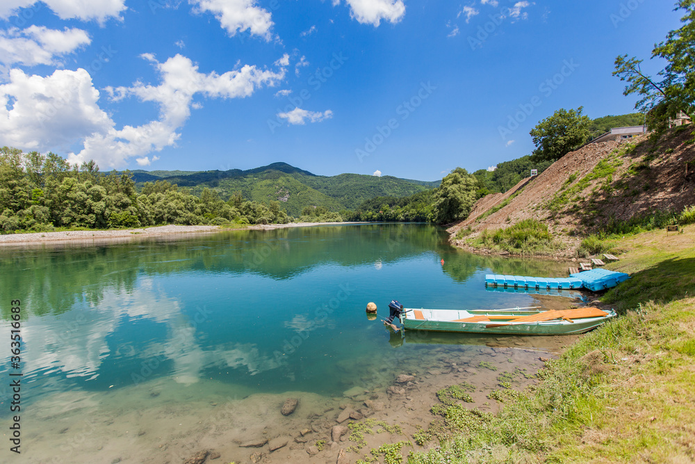 Summer day at the river, beautiful nature , view on wooden boats on the water Summer day at the river, beautiful nature , view on wooden boats on the water
