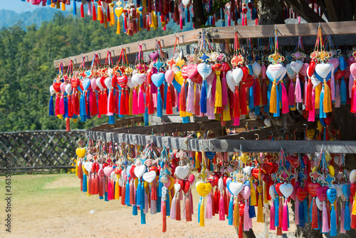 The multitude of colorful hearts with tassels for wishes and names of visitors on the stand of Yun Lai viewpoint in Santichon Village, Pai, Mae Hong Son Province, Thailand. photo