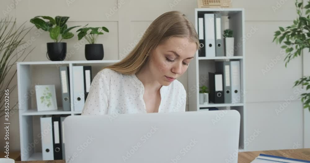 Businesswoman writing notes in book at office Businesswoman writing notes in book at office