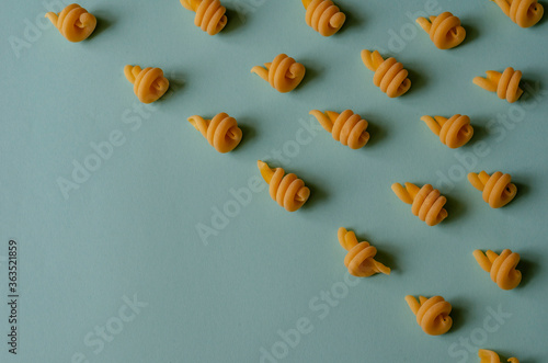 Creative background with insalatonde pasta on a light blue background. photo