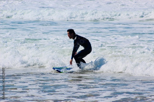 Photography 20s man surfing in CA, the US