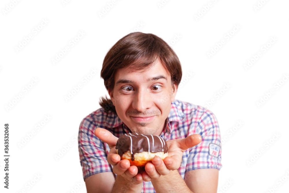 Funny man looks at the chocolate doughnut bulging eyes, a very funny photo on a white background. Empty space for text. A man loves sweets chocolate. World Chocolate Day stock images Funny man looks at the chocolate doughnut bulging eyes, a very funny photo on a white background. Empty space for text. A man loves sweets chocolate. World Chocolate Day stock images