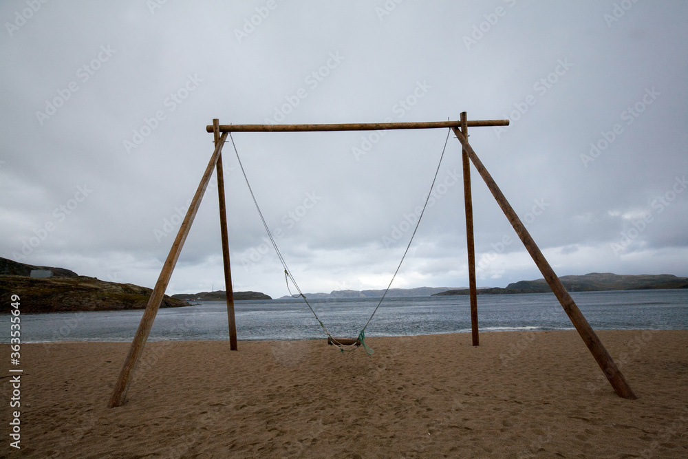 Wooden Swing at Arctic Ocean, Terabika, Murmansk, Russia Wooden Swing at Arctic Ocean, Terabika, Murmansk, Russia
