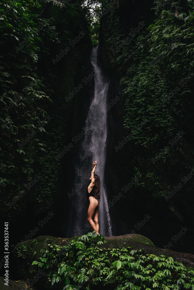 Young and beautiful girl taking bath in a waterfall Young and beautiful girl taking bath in a waterfall
