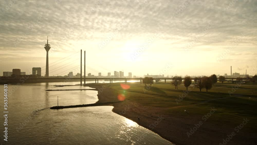 Tranquil river and Rhine Tower at sunset, Duesseldorf, North Rhine-Westphalia, Germany Tranquil river and Rhine Tower at sunset, Duesseldorf, North Rhine-Westphalia, Germany