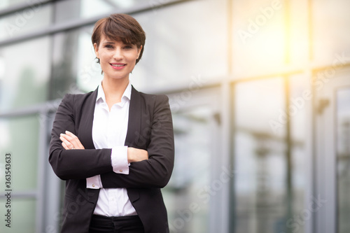 a smiling businesswoman posing outdoors