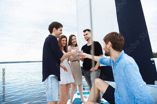 Wall Mural Group of happy friends drinking vodka cocktails at boat party outdoor, cheerful and happy