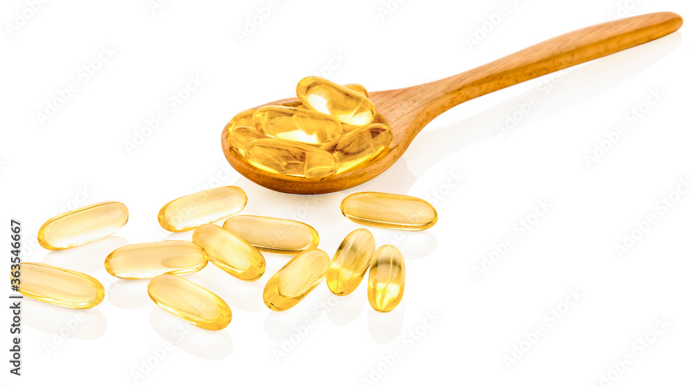 Fish oil capsules in a spoon Fish oil capsules in a spoon