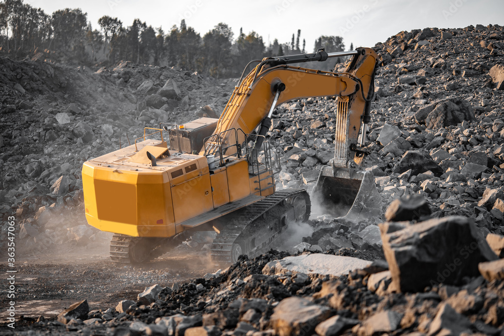 Yellow excavator works and extracts coal from bowels of earth. Open pit mine industry Yellow excavator works and extracts coal from bowels of earth. Open pit mine industry