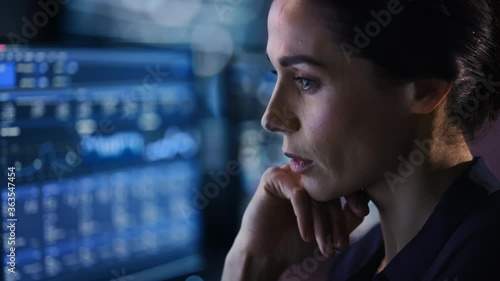 Confident Beautiful Middle Aged Woman Looks at Monitor Screens Focused