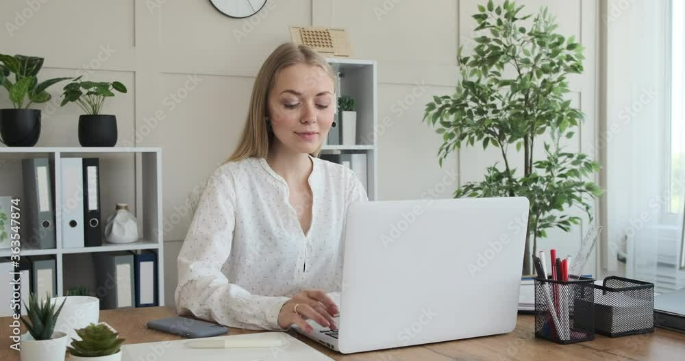 Portrait of happy businesswoman working on laptop at office Portrait of happy businesswoman working on laptop at office