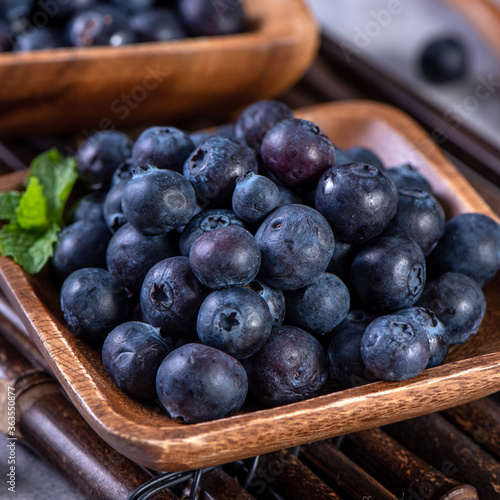 Wallpaper Mural Pile of blueberry fruit in a bowl plate on a tray over gray cement concrete background, close up, healthy eating design concept. Torontodigital.ca