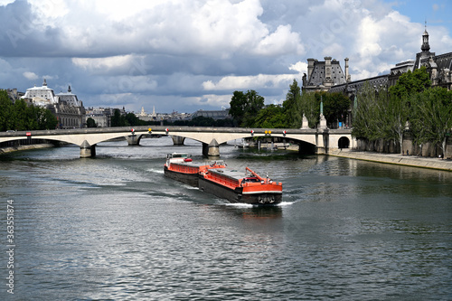 Leinwand Poster Long barge on the Seine river in Paris