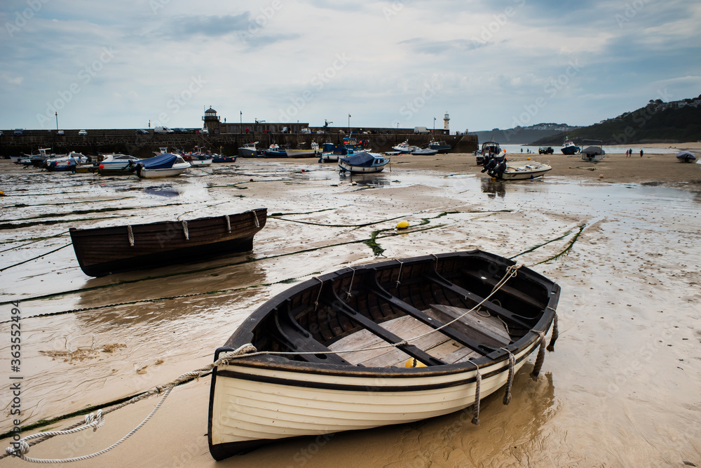 View of boats in St. Ives beach at low tide in Cornwall in England