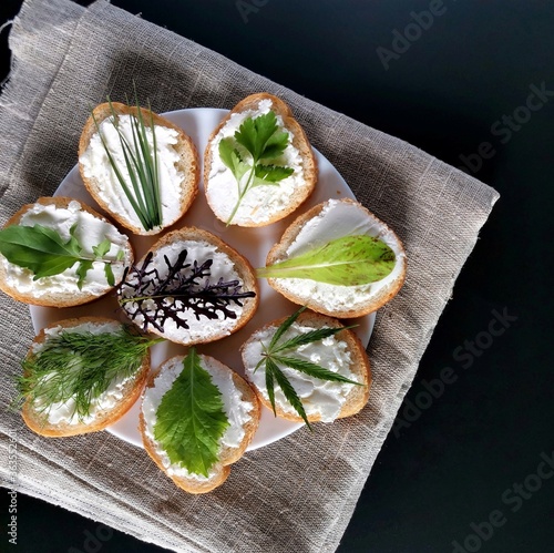 useful sandwiches with different greens and cheese on the burlap and a dark background 