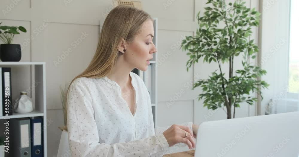 Businesswoman working on laptop and opening notebook at office Businesswoman working on laptop and opening notebook at office