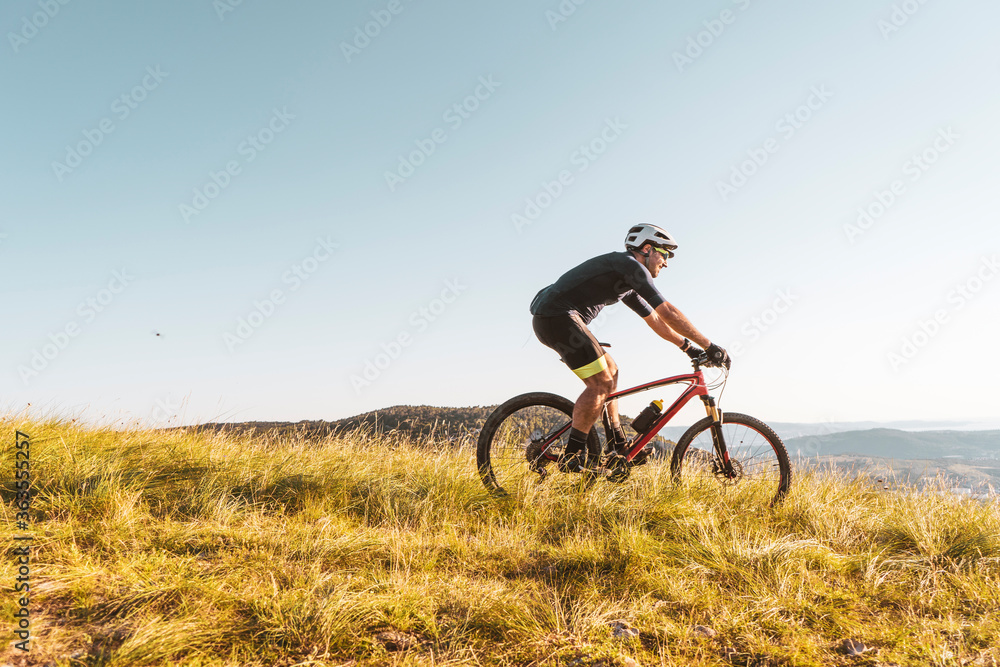 Man riding his mountain bike outdoor in nature Man riding his mountain bike outdoor in nature