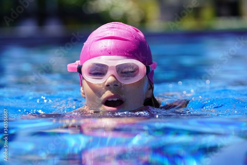 Young girl training in outdoor swimming-pool © goodluz