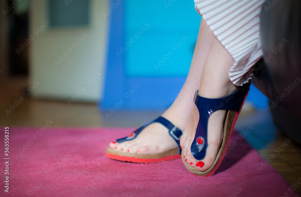 Girls feet with red nails in pink carpet Girls feet with red nails in pink carpet