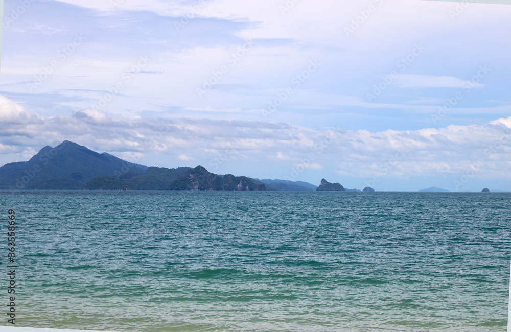 Beach with blue water and background of small island at Langkawi Malaysia, Asia