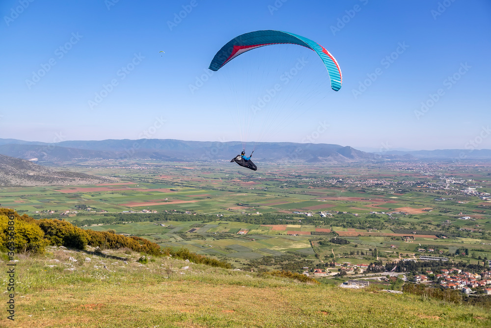 Paraglider in the popular area for parachuting on the side of Korylovos in Drama Paraglider in the popular area for parachuting on the side of Korylovos in Drama