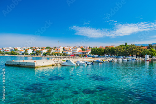 Croatia, town of Novalja on the island of Pag, marina with boats and turquoise sea in foreground, tourist destination on Adriatic sea