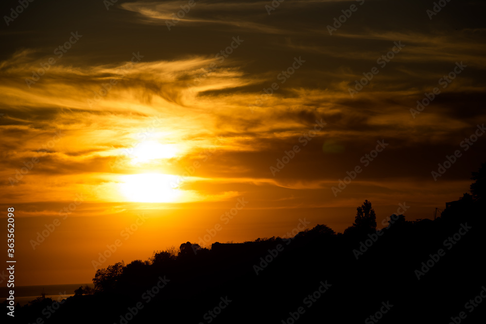 Contrast background with a bright setting sun and cloud Contrast background with a bright setting sun and cloud