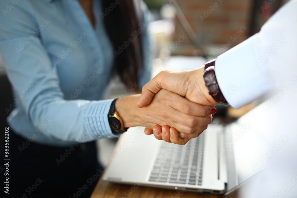 Man and a woman in office shake hands. Successful agreement business partners concept Man and a woman in office shake hands. Successful agreement business partners concept