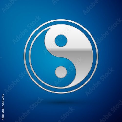 Silver Yin Yang symbol of harmony and balance icon isolated on blue background. Vector Illustration.