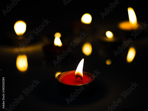 Wallpaper Mural concept of mourning the dead from the corona virus represented by warm candles,COVID-19. Selective Focus Torontodigital.ca