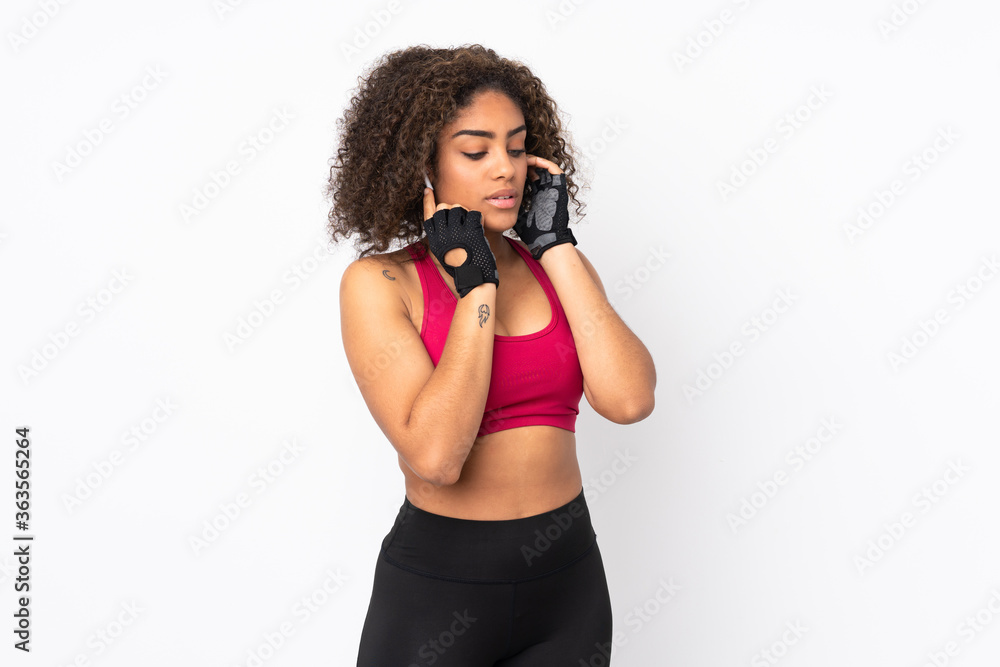 Young African American sport woman isolated on white background listening music Young African American sport woman isolated on white background listening music