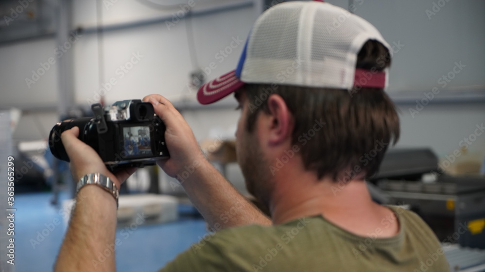 Videographer shooting the production process at the factory Videographer shooting the production process at the factory